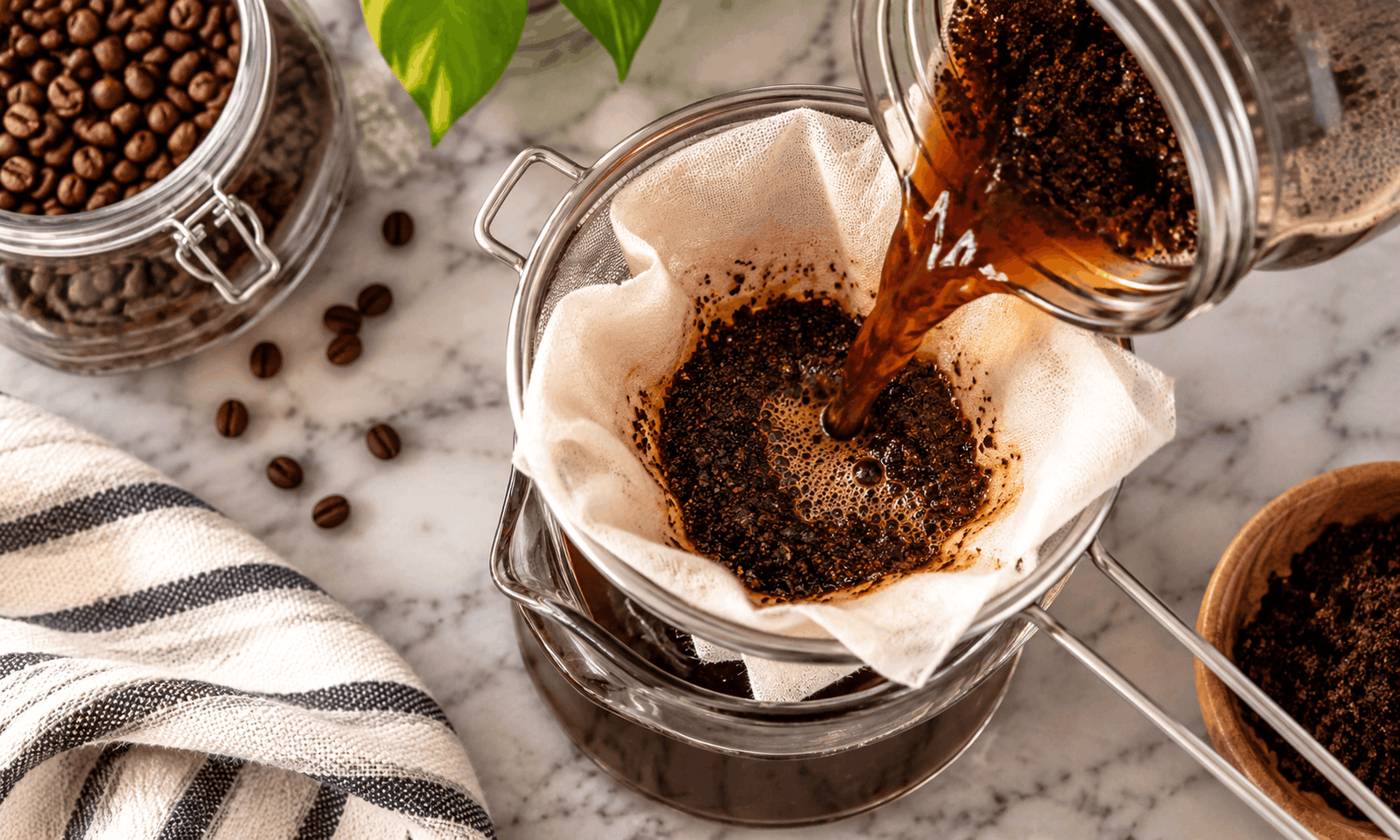 Straining cold brew coffee through a sieve and filter